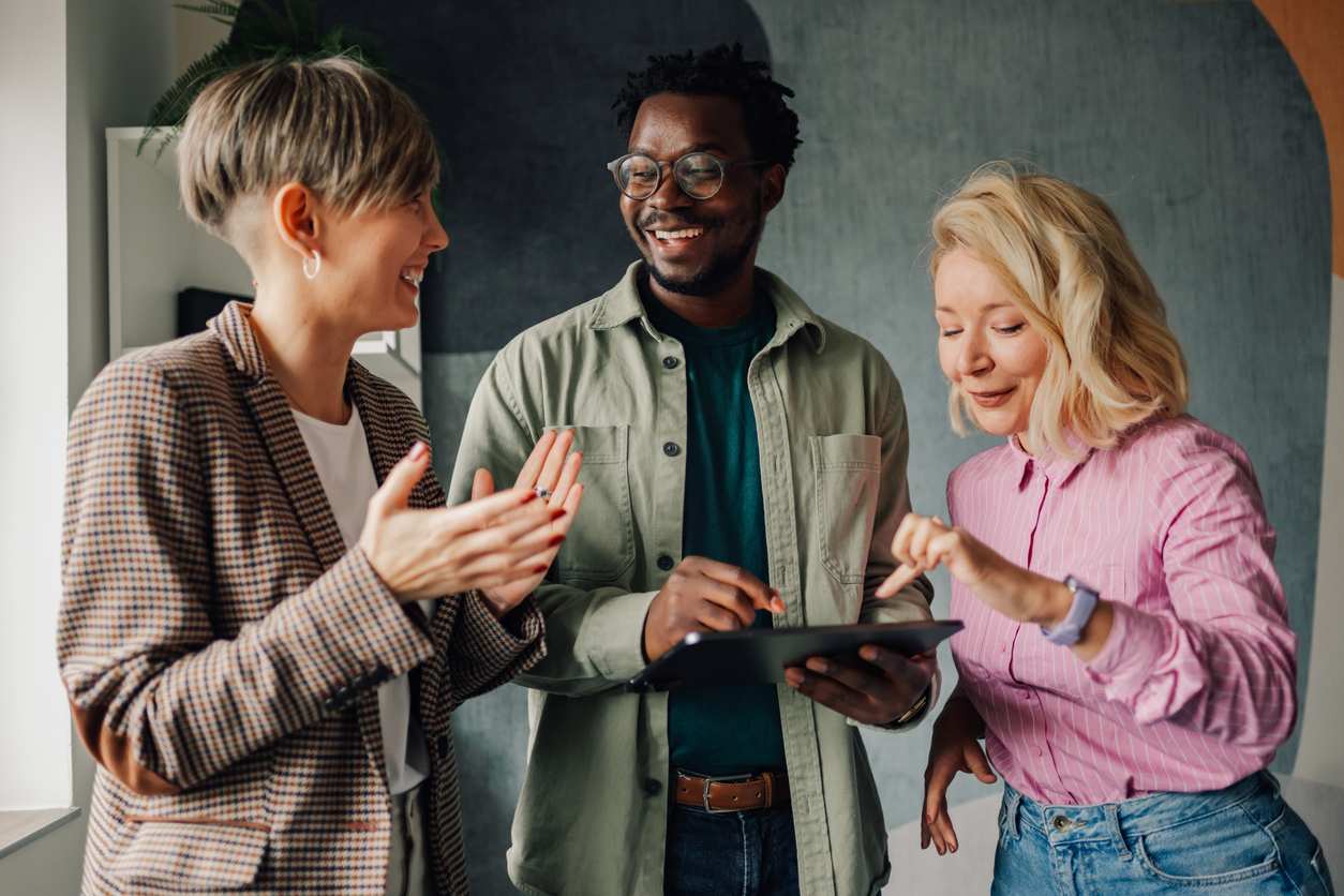 Business people collaborating on digital tablet in office Business people collaborating on digital tablet in office