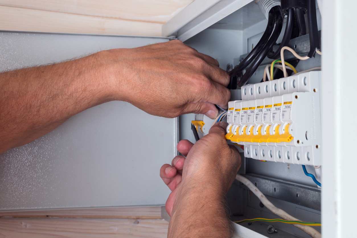 Electrician connecting cables Electrician connecting cables